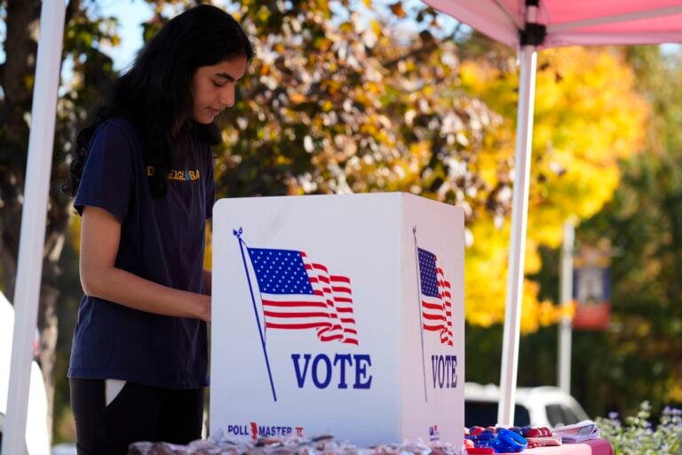 Shreya Srinivasan fills out her mail-in ballot at a Montgomery County voter services mobile location in King of Prussia, Pa., Tuesday, Oct. 22, 2024