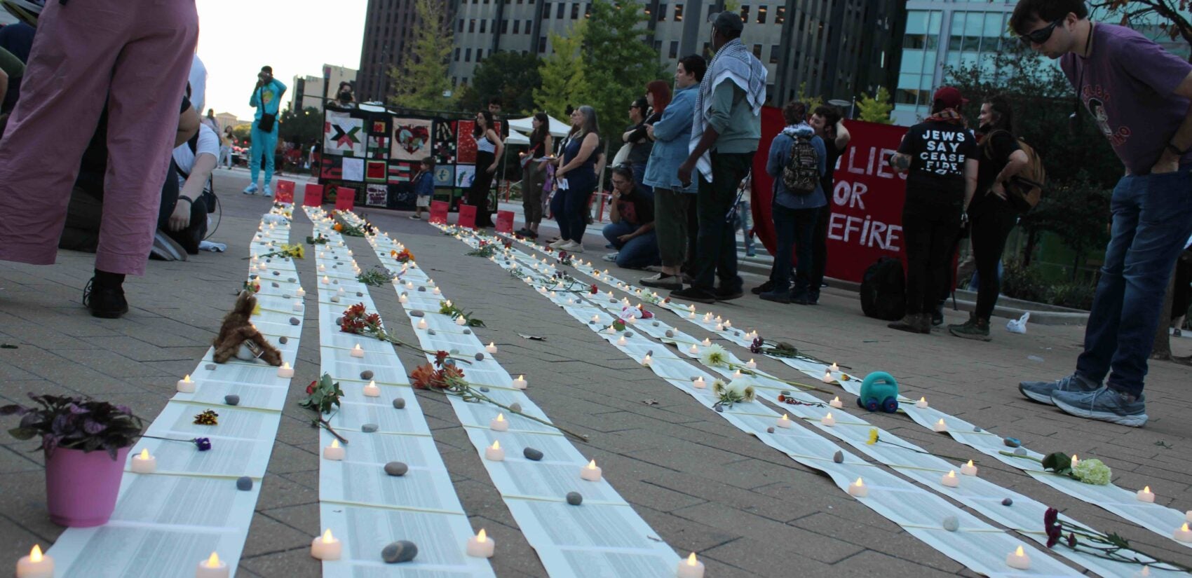 Attendees placed 710 candles on the ground, representing the number of children in Gaza killed in the past year before their first birthday. (Emily Neil/WHYY)