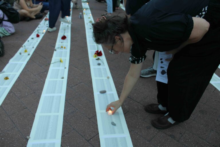 Attendees placed 710 candles on the ground, representing the number of children in Gaza killed in the past year before their first birthday. (Emily Neil/WHYY)