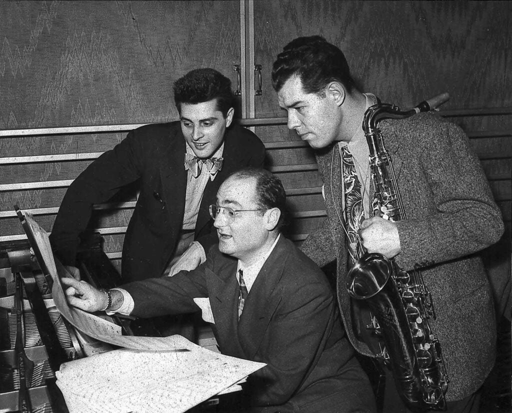 Tex Beneke, Jerry Gray and Johnny Desmond read music