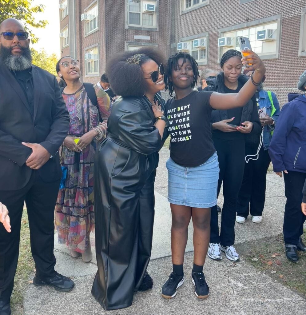 Jill Scott poses as a student takes a selfie with her