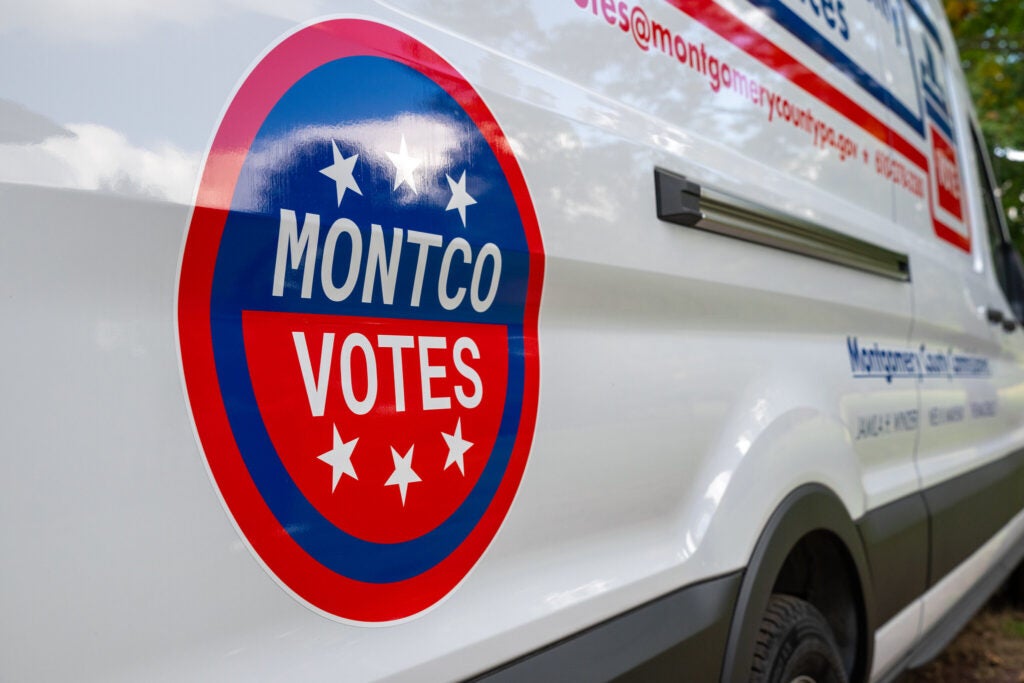 A sign on the side of a van reads "Montco votes"