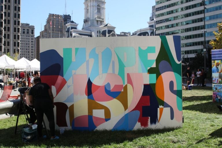 a mural reads HOPE RISES