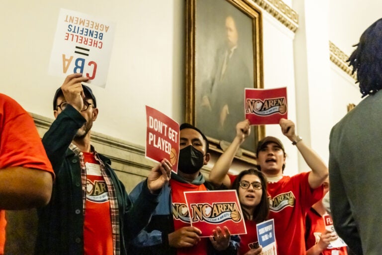 Members of the No Arena in the Heart of Our City Coalition protesting, holding signs