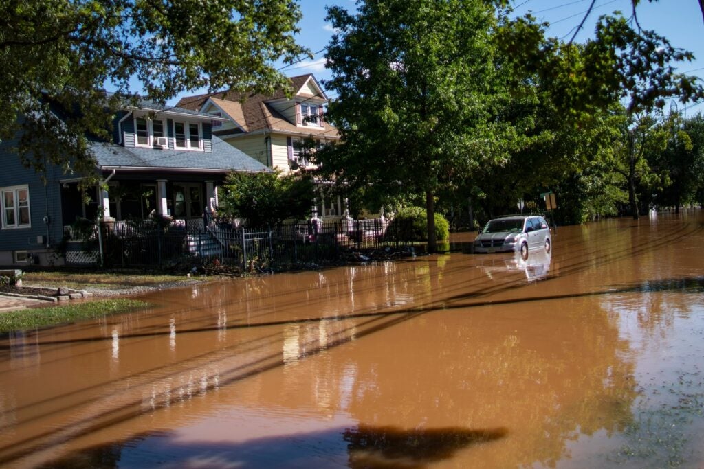 a flooded street in Somerville, in front of houses