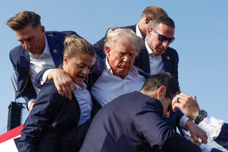 Donald Trump is carried by U.S. Secret Service agents in Butler following an assassination attempt