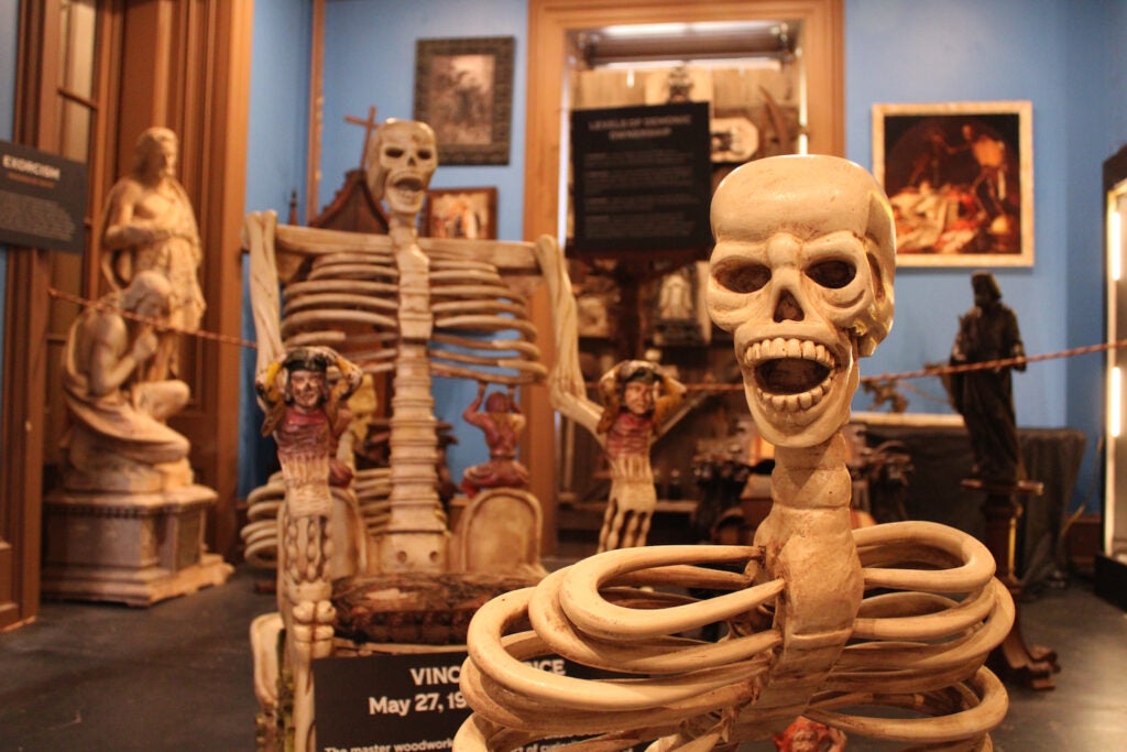 A carved chair, allegedly owned at one time by Vincent Price, on display