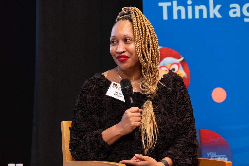 Marsha Hallager speaks into a microphone