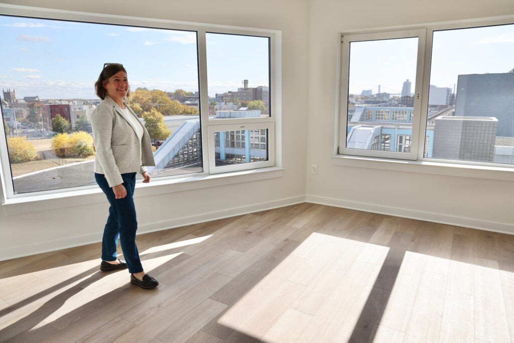 Kelli Tomczak smiles in an apartment