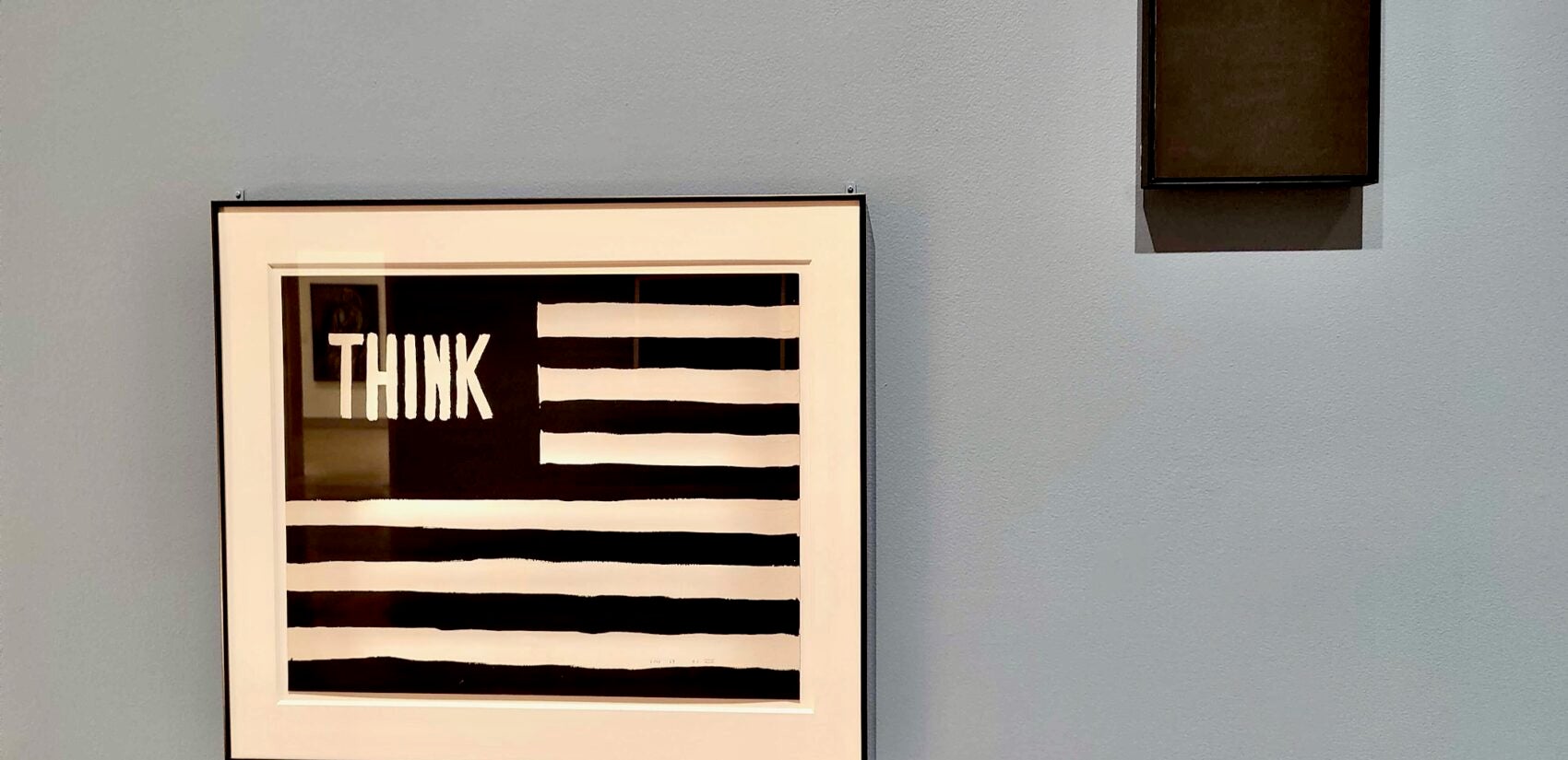 Wilson Nelson Copley's ''Untitled (Think)'' (1967) and Ad Reinhardt's ''Black Cross'' from the same year, are paired in ''What Times are These?'' at the Philadelphia Museum of Art. (Peter Crimmins/WHYY)