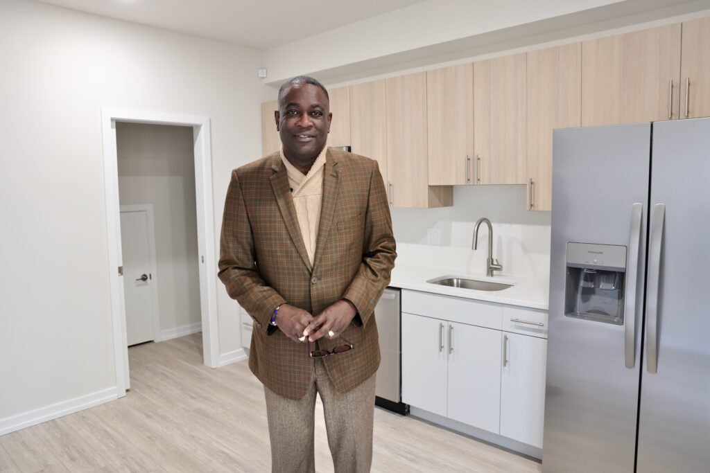 Kelvin Jeremiah stands in the kitchen of a newly constructed affordable housing unit