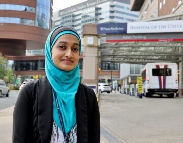 A doctor stands outside of the Hospital of the University of Pennsylvania