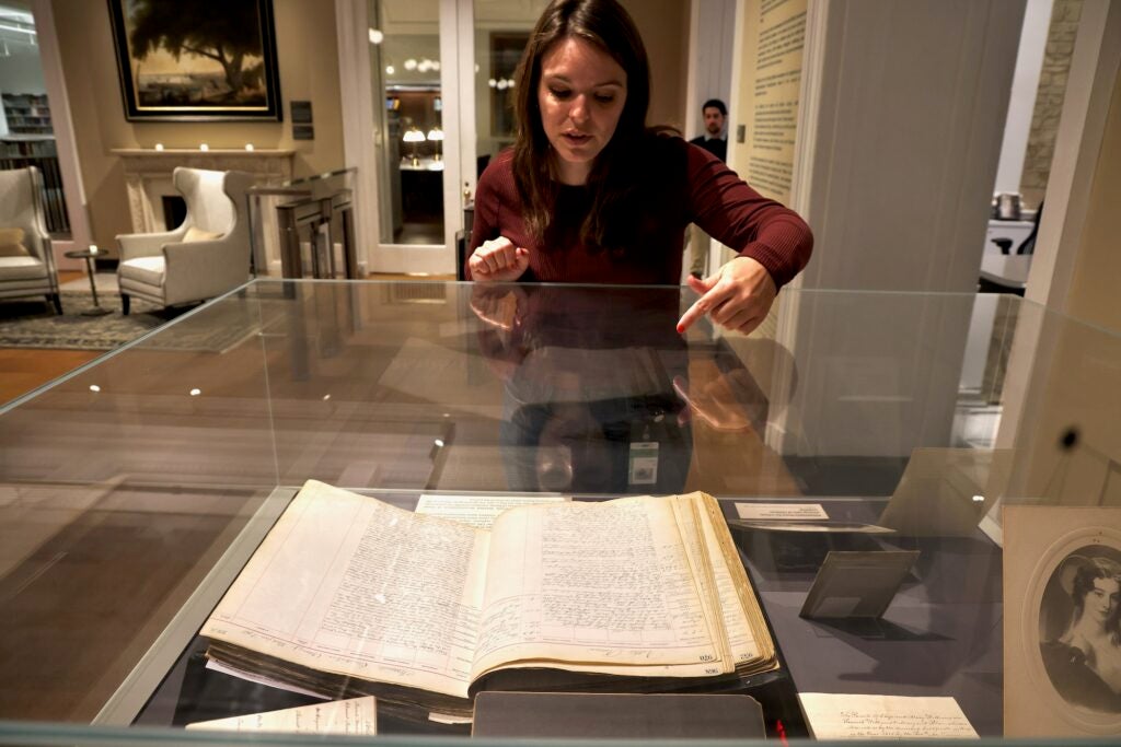 Katy Bodenhorn Barnes looking at items in the exhibit