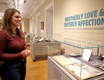 Katy Bodenhorn Barnes looking at items in the exhibit