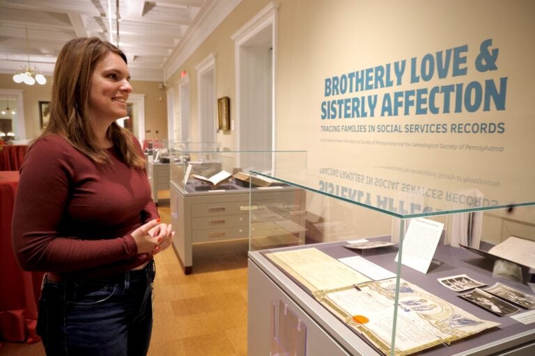 Katy Bodenhorn Barnes looking at items in the exhibit