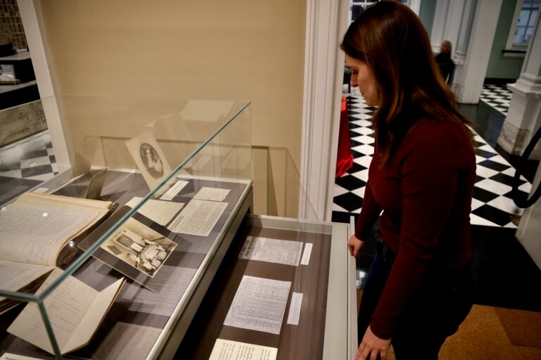 Katy Bodenhorn Barnes looking at items in the exhibit