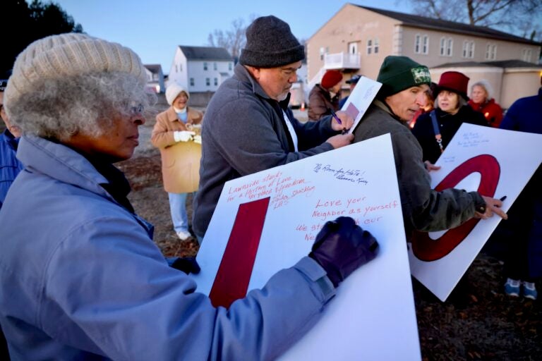 People write messages on signs