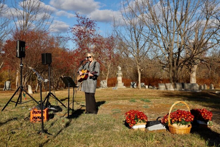 Andrea Miles, a descendant of Revolutionary War veteran Col. Samuel Miles, sings ''Go Rest High on that Mountain'' during a memorial service for the nearly 500 parishioners of the First Baptist Church of Philadelphia whose remains were relocated from a construction site to Mount Moriah Cemetery. (Emma Lee/WHYY)