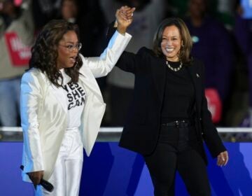 Oprah Winfrey holds hands with Democratic presidential nominee Vice President Kamala Harris after introducing Harris to speak during a campaign rally outside the Philadelphia Museum of Art, Monday, Nov. 4, 2024, in Philadelphia. (AP Photo/Matt Slocum)