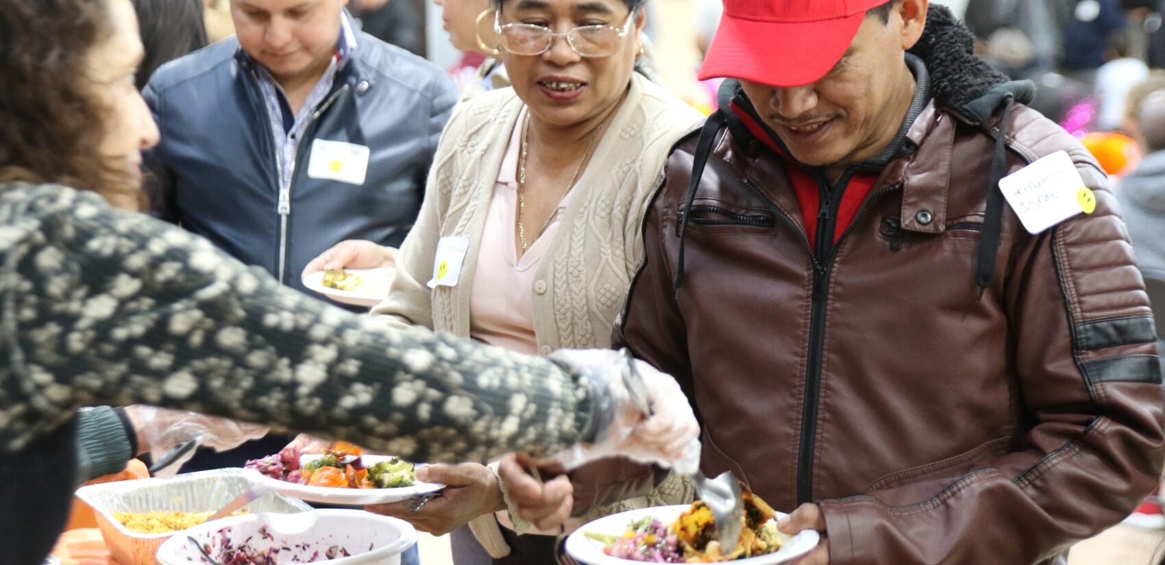 an adult receives a plate of food