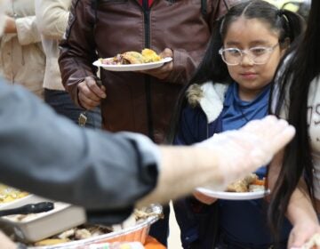 a child receives a plate of food