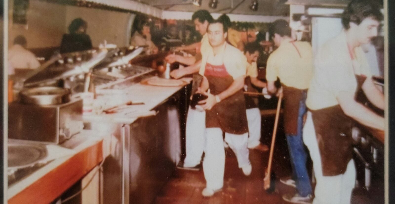 The Scotto Pizza crew hustles in the kitchen in 1986.