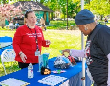 Sunny Jackson talks to someone at a booth