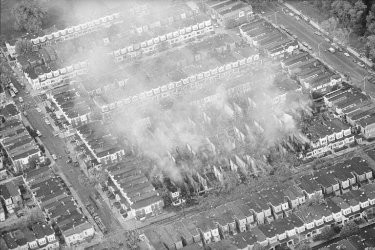 Smoke rises from the ashes of a West Philadelphia neighborhood, May 4, 1985, the morning after a siege between Philadelphia police and members of the radical group MOVE left 11 people dead and 61 homes destroyed