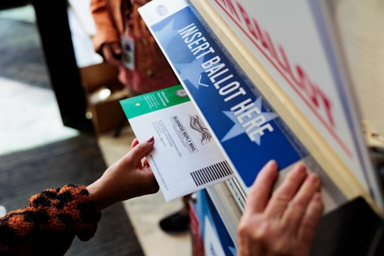 mail ballot being dropped in a box