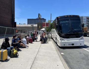 Passengers wait to board Peter Pan bus