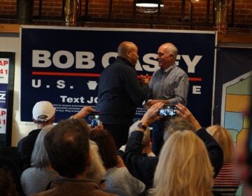 Cory Booker and Bob Casey embrace onstage