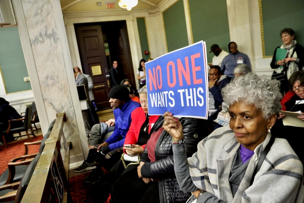 a sign held by an audience member reads no one wants this