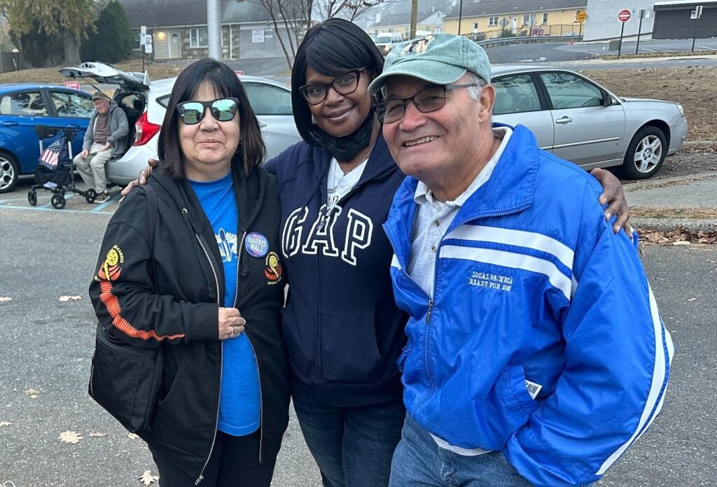 Carol Rodriguez (left), Lynette Willis (center) and Fidel Rodriguez appear at their polling station in Philadelphia