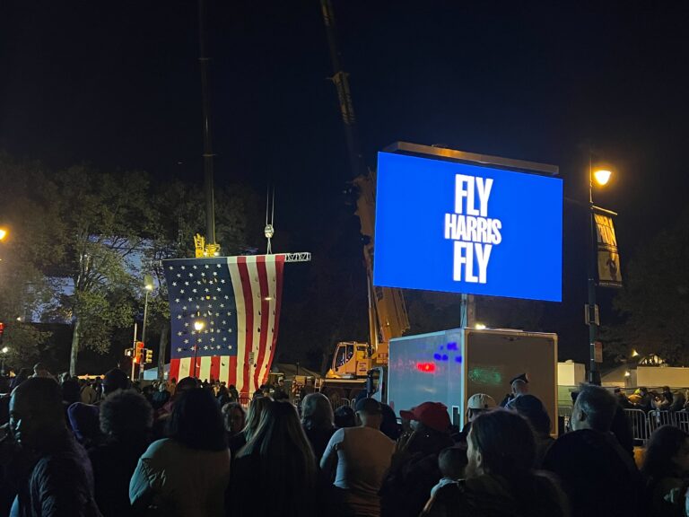 the crowd, and a signs reads FLY HARRIS FLY