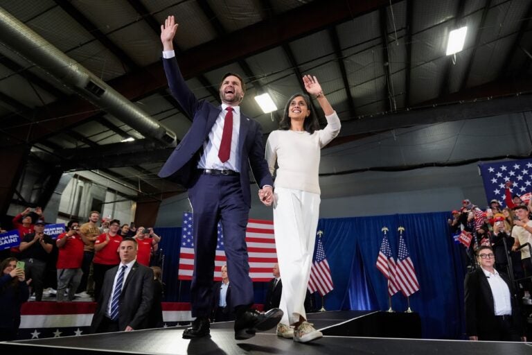 JD Vance holds his wife's hand onstage