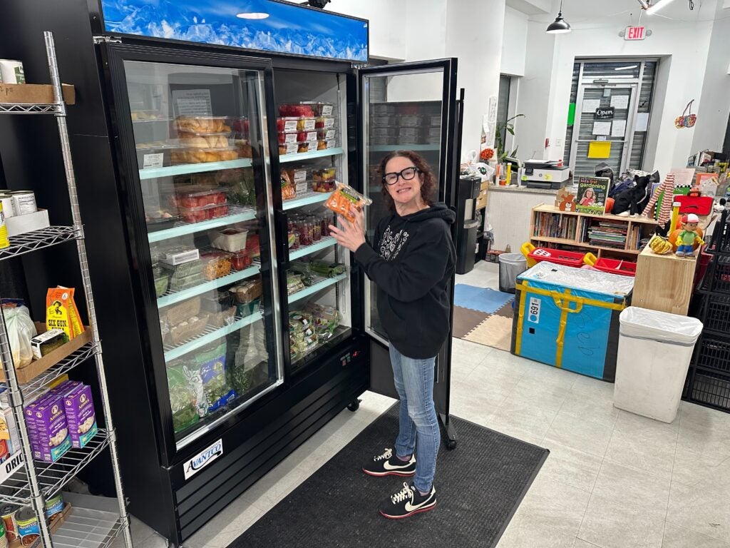 Margaux Murphy at the fridge at the food pantry