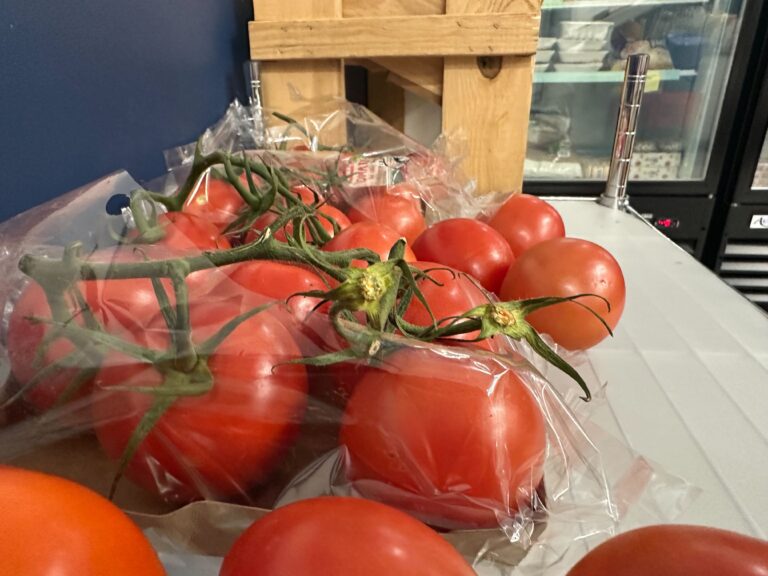 A bunch of tomatoes sitting on the counter