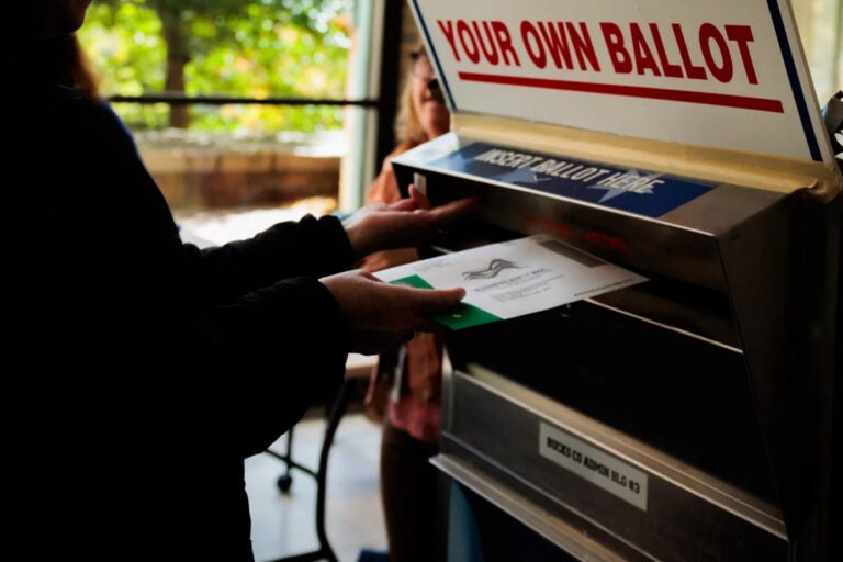 A person drops off a mail-in ballot in October in Doylestown, Pa. Pennsylvania county officials received thousands of last-minute challenges to voters’ absentee ballot applications, most of which were withdrawn shortly after Election Day. (Hannah Beier/Getty Images)