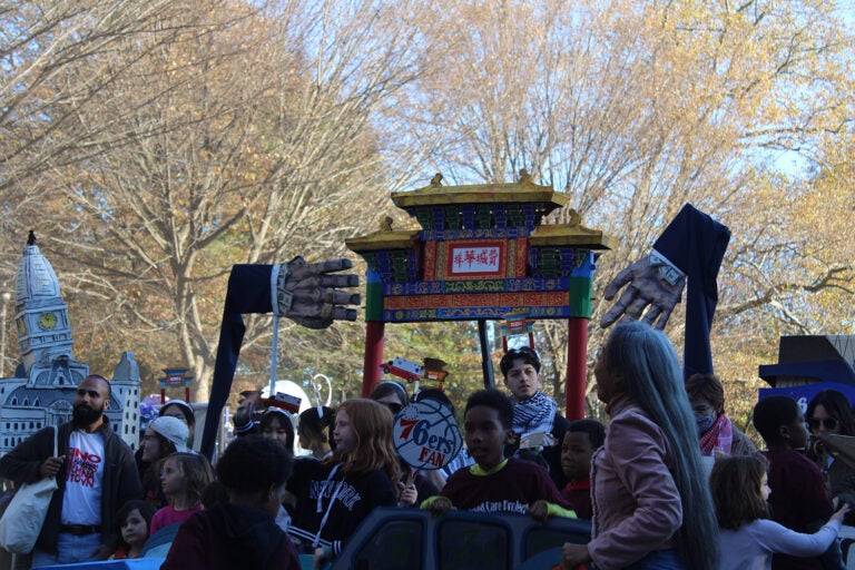 The pageant criticized Mayor Cherelle Parker's support for the 76ers' arena proposal, and members of the No Arena coalition spoke. (Emily Neil/WHYY)