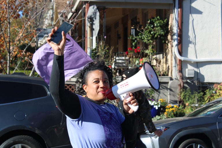 Jennifer Turnbull, co-executive director of Spiral Q, which organized the parade, led the group towards Clark Park. (Emily Neil/WHYY)