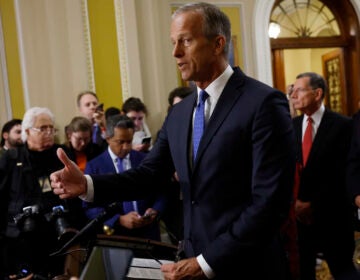 Republican Sen. John Thune stands at a podium