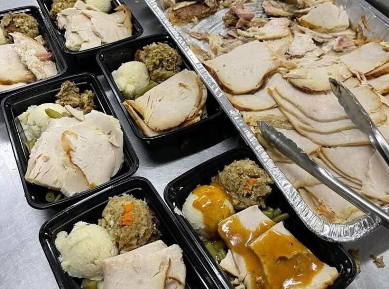 Thanksgiving plates of turkey with gravy, stuffing, mashed potatoes and green beans