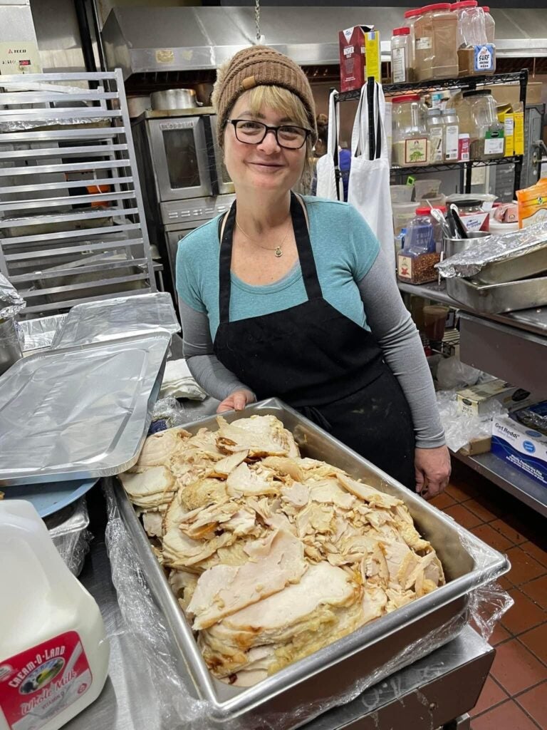 Anh Vongbandith smilees next to turkey slices