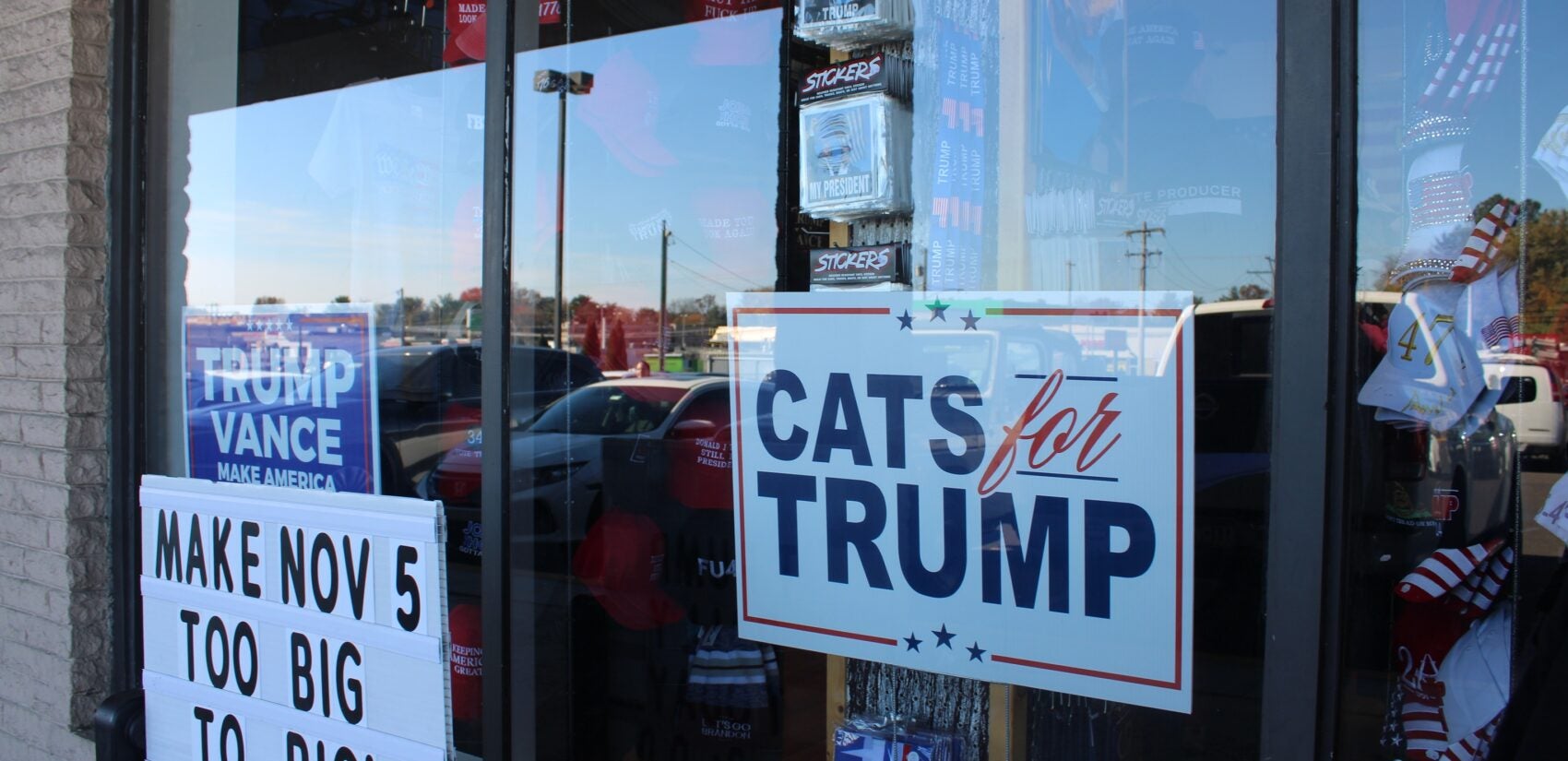 a sign on a window reads CATS for TRUMP