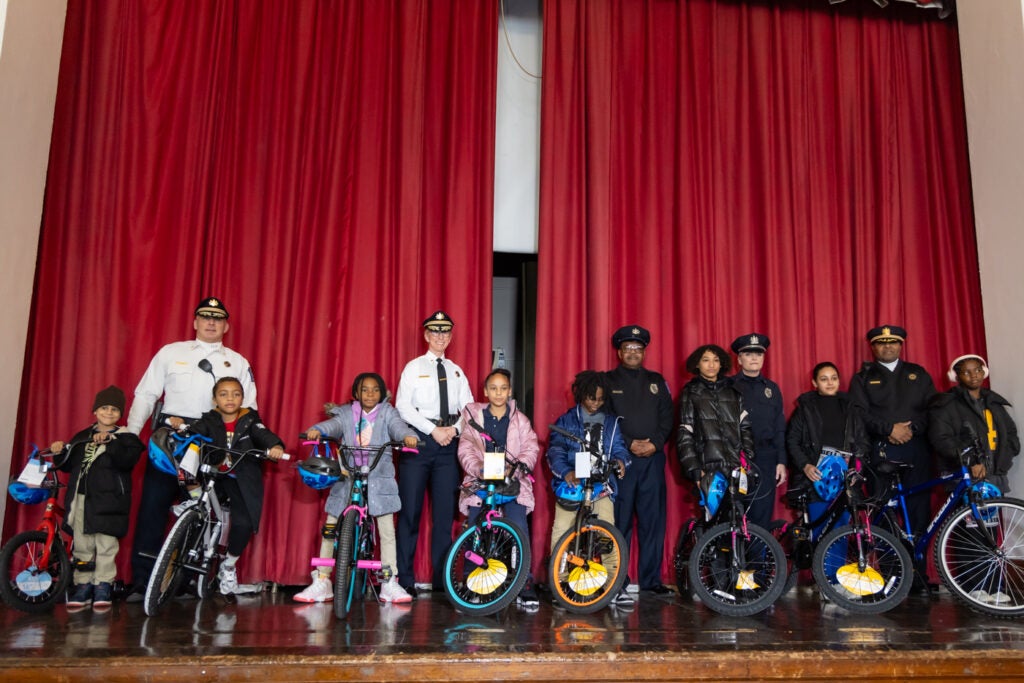 students on bikes on stage with Temple Police