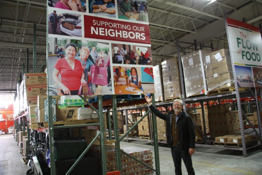 Fred Wasiak posing for a photo inside a big warehouse