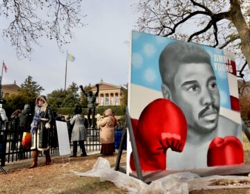 A large portrait of Jimmy Young holding up his boxing gloves