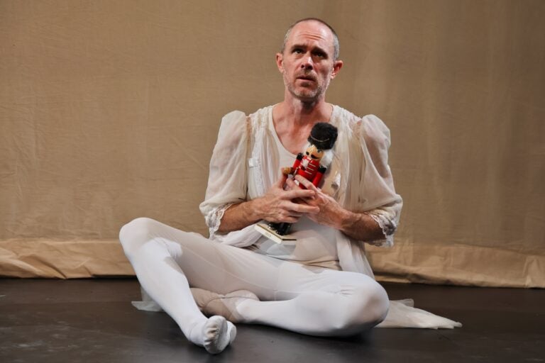 Chris Davis performing ballet while holding a nutcracker