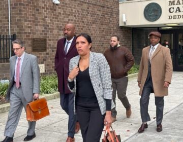 A group of people walking out of a courthouse