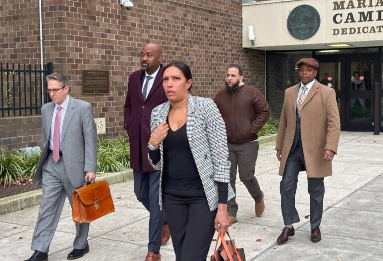 A group of people walking out of a courthouse